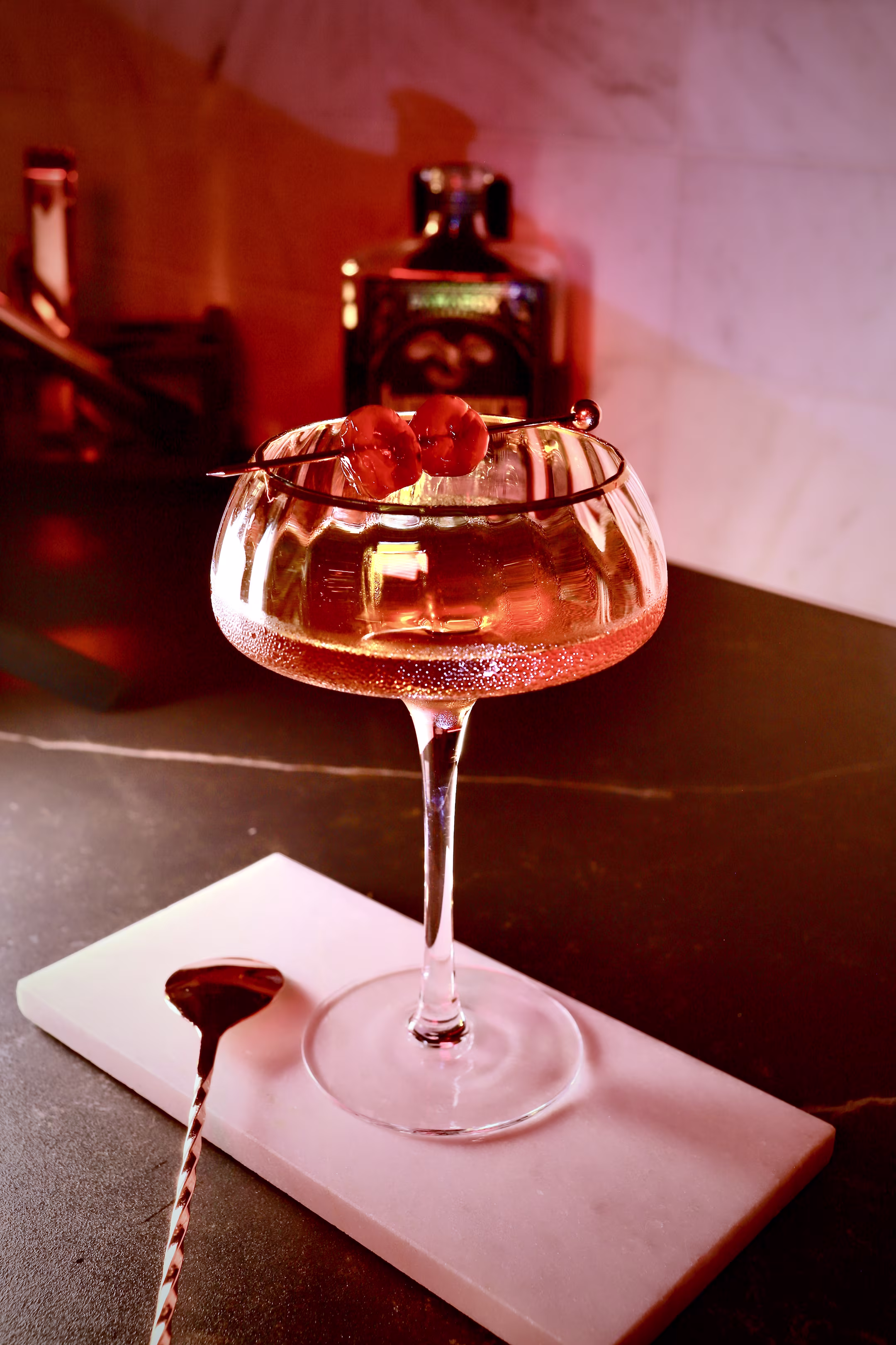 Traditional Manhattan cocktail served in a Nick & Nora glass with a Luxardo cherry garnish.